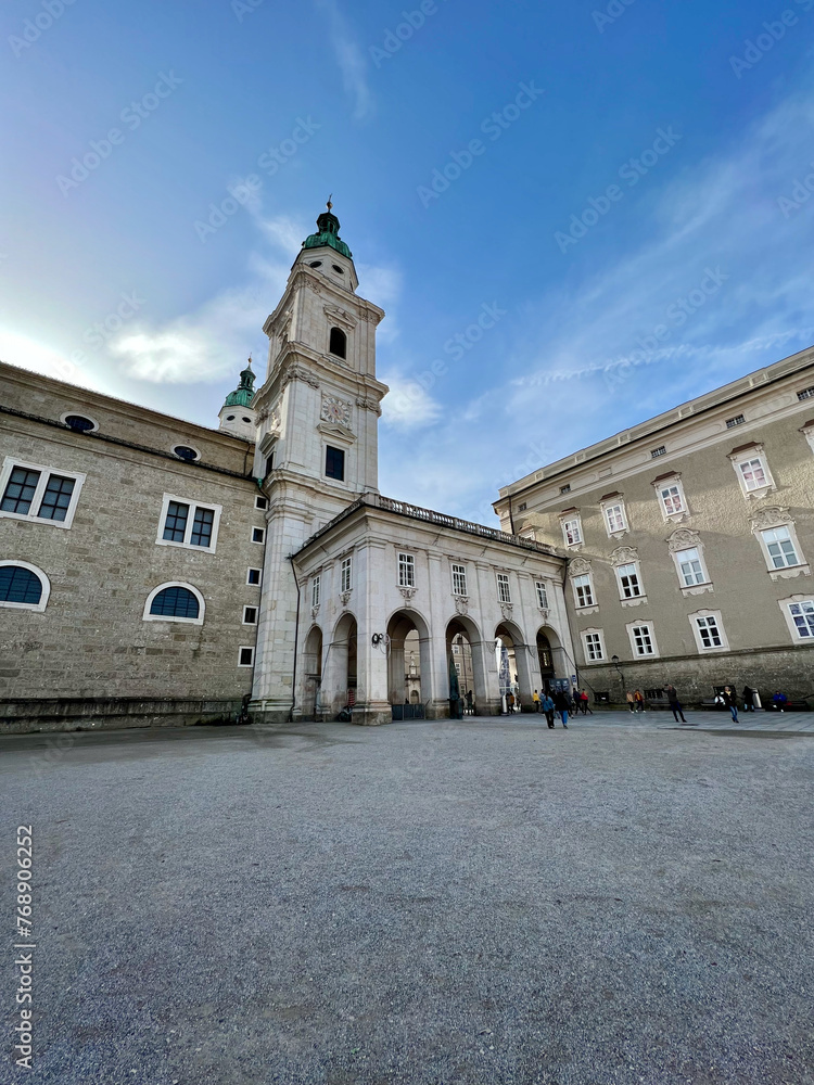 Obraz premium Salzburg, Austria - Nov 1 2023: Historic gate linking Residenzplatz to Domplatz in Salzburg, Austria. Ornate details and classical design frame a picturesque view of the city's landmarks. 