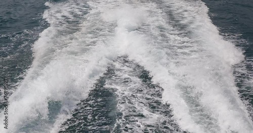 Ship wake up in the ocean. aves from the back of a speed boat over the water's surface in the sea. Waves behind a boat on a clear blue sea