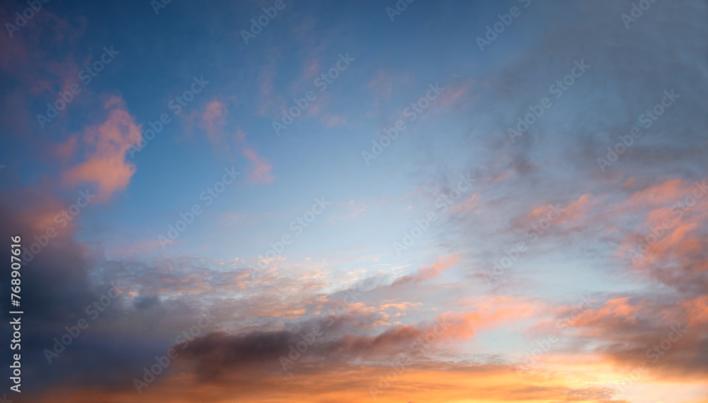 romantic sunset sky with pink clouds, blue in the upper half