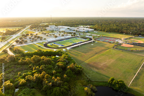 Sports facilities at public school in North Port, Florida. American football stadium, tennis court and baseball diamond sport infrastructure