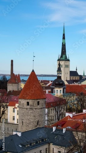 Timelapse of aerial view of Tallinn Medieval Old Town in day with blue sky, Estonia with camera zoom out photo