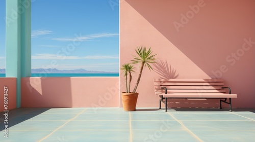 Palm tree in front of pink wall with blue ocean view