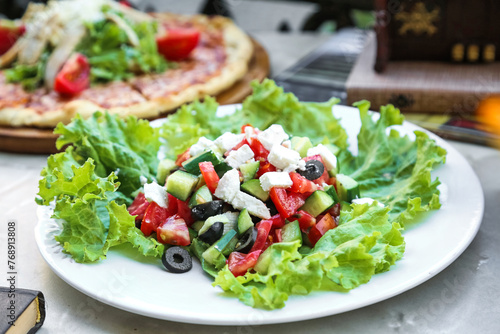 Fresh Salad and Pizza on a White Plate