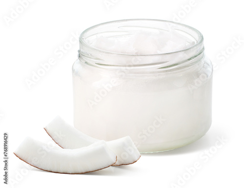 Glass jar of coconut oil and fresh coconut pieces on white background