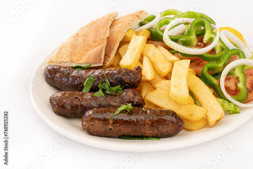 grilled sausages with french fries and salad