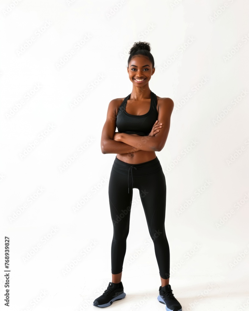 Fototapeta premium Portrait, fitness and arms crossed with happy black woman in studio on white background for health. Exercise, smile and workout with confident young sports model training for improvement