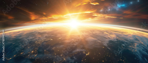 Beautiful panoramic view of planet Earth atmosphere from space with sun rays, city lights, clouds, and distant star galaxies. Dramatic globe horizon panorama banner background backdrop wallpaper