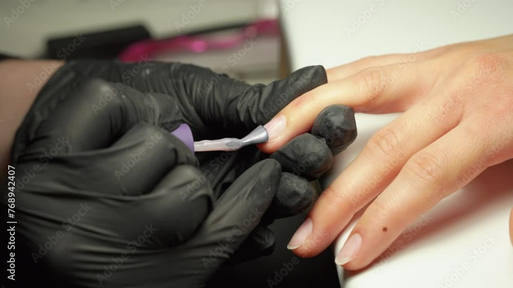 Nail acrylic polish applied onto nail, by nail technician Nail acrylic polish applied onto nail, by nail technician