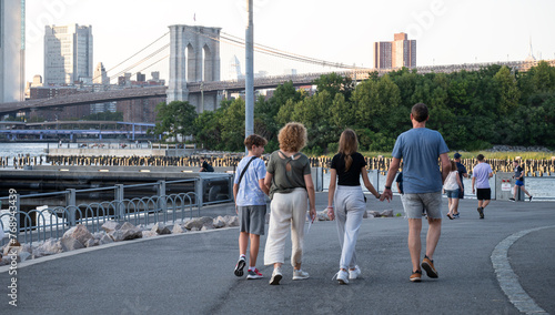 Family Walk Along the Brooklyn Bridge Park at Dusk photo