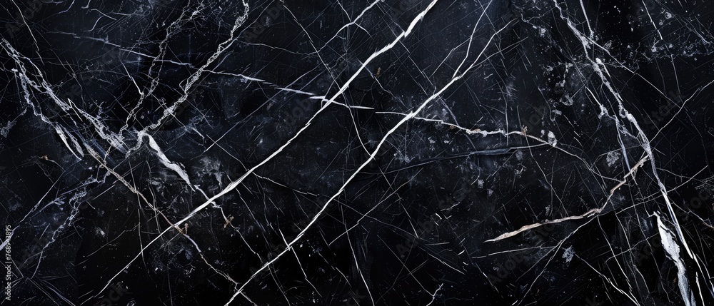 Sleek black marble texture with intricate white veining polished surface reflecting light