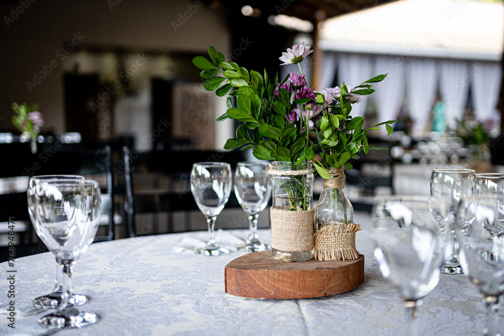 Table arrangement with green flower and glasses on the wooden table
Table arrangement with green flower and glasses on the wooden table
