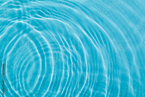 drops on water with circles on a blue background