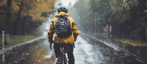 Portrait of a man riding a bicycle on a city street during heavy rain