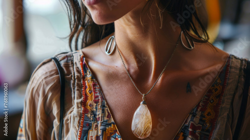 A boho-chic woman showing off her unique pendant necklace, reflecting a free-spirited lifestyle
