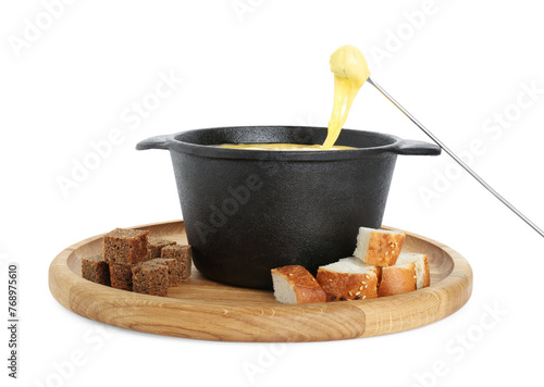 Dipping piece of bread into fondue pot with tasty melted cheese isolated on white