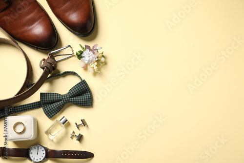 Wedding stuff. Flat lay composition with stylish boutonniere on yellow background, space for text