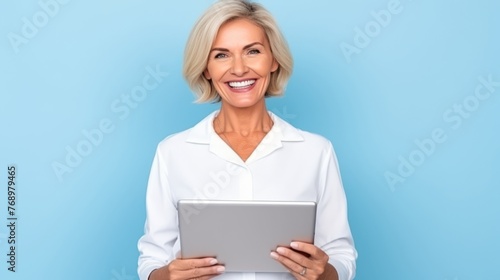 Mature female experienced doctor, healthcare professional, dentist, stomatologist, nurse smiling on a blue background