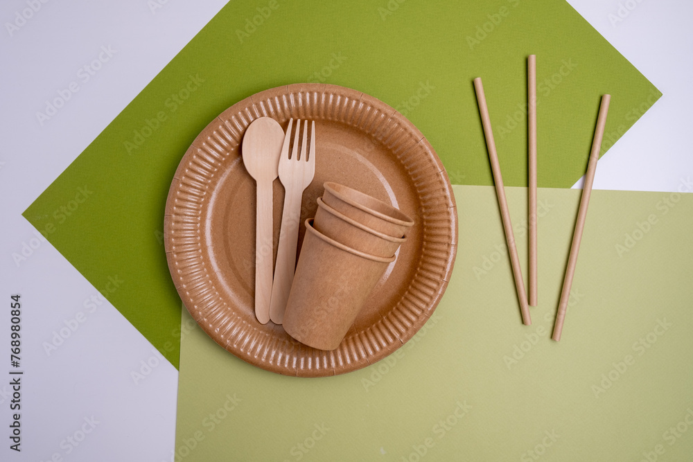 Kraft paper tableware: cups, food boxes, isolated on a light background. A set of various disposable tableware. Recycling and zero waste concept. Mock up Kraft paper tableware: cups, food boxes, isolated on a light background. A set of various disposable tableware. Recycling and zero waste concept. Mock up