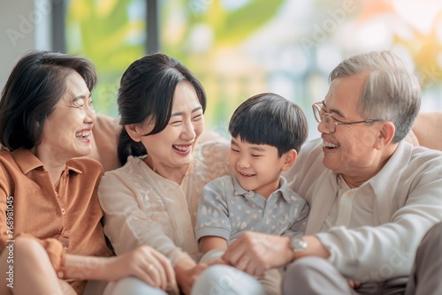 Happy asian family enjoying weekend and laughing together at home