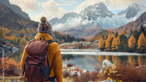 Woman immersed in nature's beauty: contemplating mountain lake amidst autumn forest - serene adventure travel scene