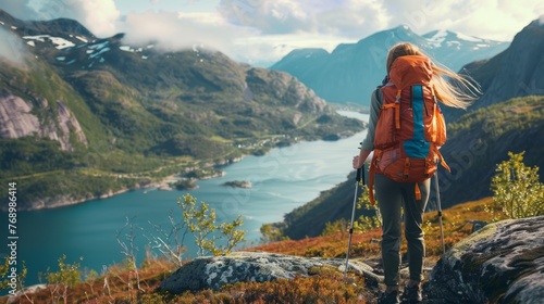 Woman adventurer trekking through norwegian mountains with backpack, embracing adventure, healthy lifestyle, and active summer vacation - explore nature's majesty in norway