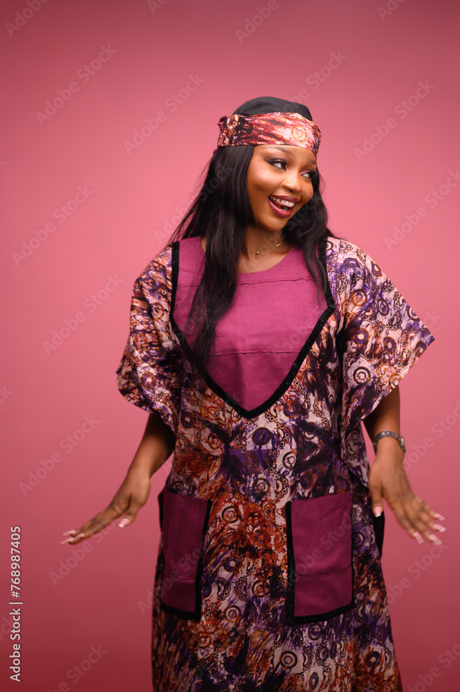 Face of a happy businesswoman in a native attire. Portrait of a young confident Nigerian entrepreneur or trendy marketing designer smiling while standing . Face of a happy businesswoman in a native attire. Portrait of a young confident Nigerian entrepreneur or trendy marketing designer smiling while standing .