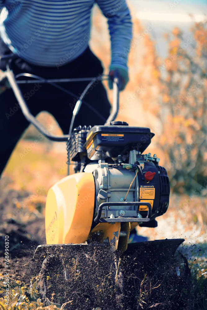 plowing the garden with special equipment on a autumn day plowing the garden with special equipment on a autumn day