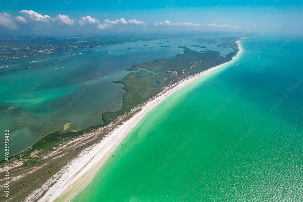 Florida. Beach on Island. Panorama of Clearwater Beach Florida. Caladesi Island State Park FL. Summer vacation. Turquoise color of salt water. Ocean or Gulf of Mexico. Tropical Nature. Aerial Aerial