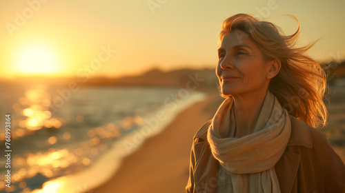 Mature woman, early 70s, walking along a beach at sunset, Casual yet stylish outfit with a light scarf, Alone but content, the setting sun casting a golden light on her face
