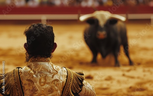 A matador in an intense standoff with a bull in the arena, under the play of shadows and sunlight.