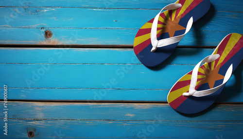 Pair of beach sandals with flag Arizona. Slippers for summer sea vacation. Concept travel and vacation in Arizona.
