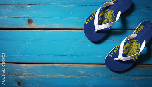 Pair of beach sandals with flag Oregon. Slippers for summer sea vacation. Concept travel and vacation in Oregon.