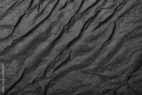 Abstract texture of crumpled black paper. Granite background