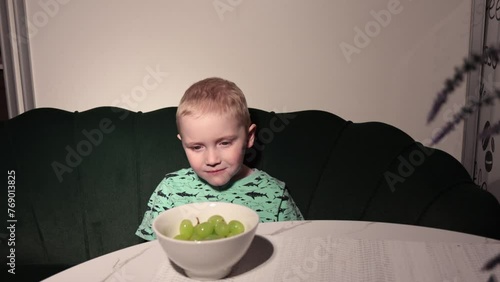 Little buy eat fresh green grape 