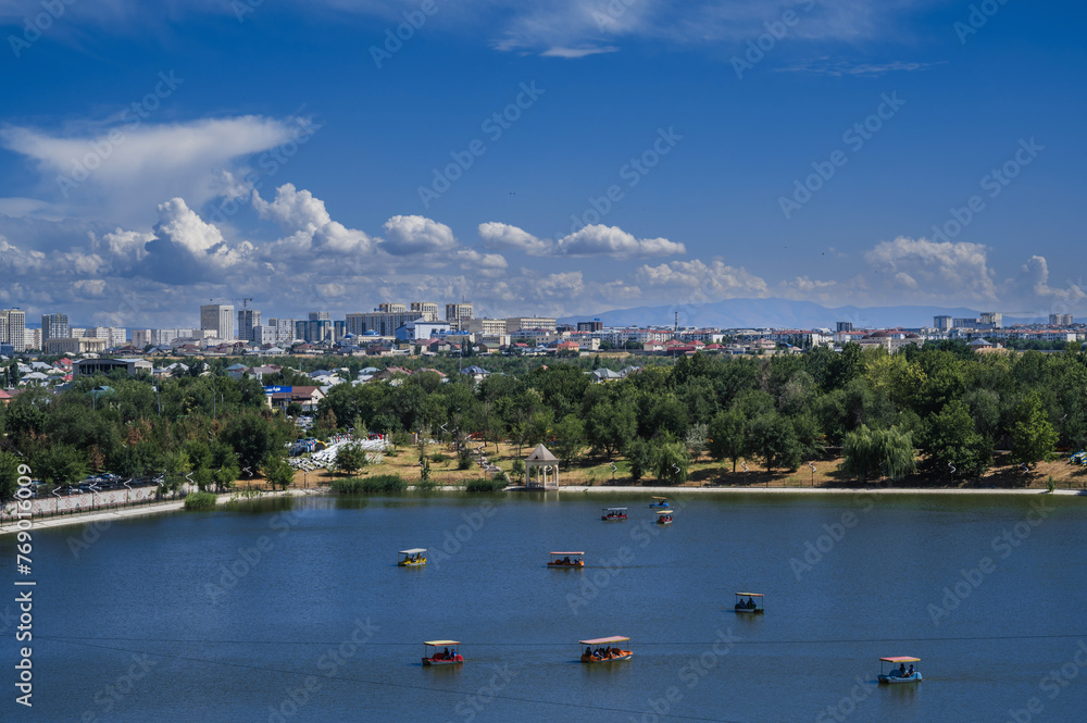 Top view from the Ferris wheel of the Altyn Eye Park and lake in Shymkent in summer