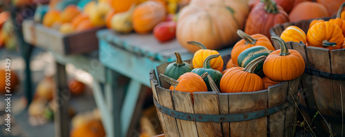 Wooden barrels and tables laden with a variety of pumpkins. Autumn harvest and Thanksgiving concept. Design for fall festival flyers banners with copy space, seasonal food market promotions, and harve photo