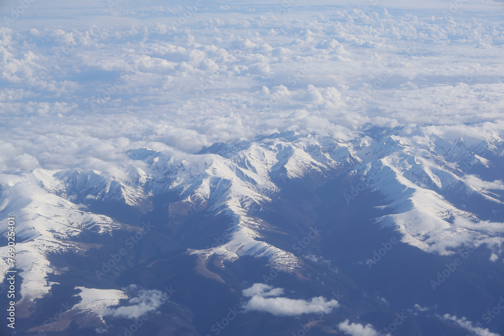 Fagaras mountains (charpathian mountains) covered with snow. Photo taken through the airplane window.