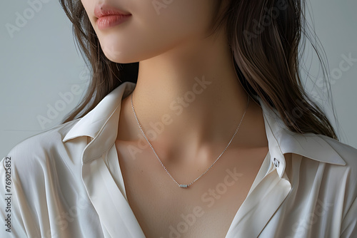 A neutral jade and minimalist silver chain necklace that is easy to match and looks cool around a neck 