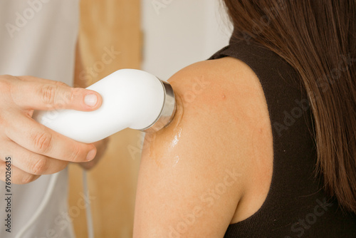 Принти на полотні Hand of a physical therapist applying ultrasound on a patient's injured shoulder