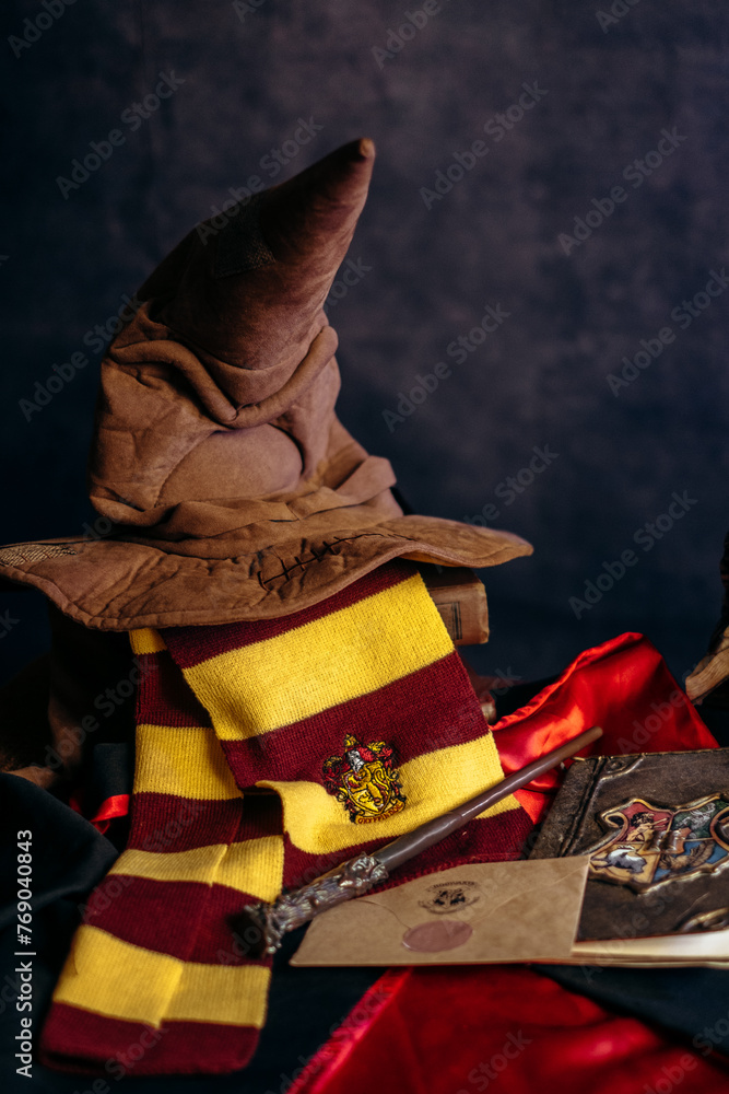 Fototapeta premium Kremenchug, Ukraine - March 21, 2024. Book of Spells, Ticket for the Hogwarts Express from platform 9 3.4 and JK Rowling's Harry Potter Magic Wand. Composition of accessories
