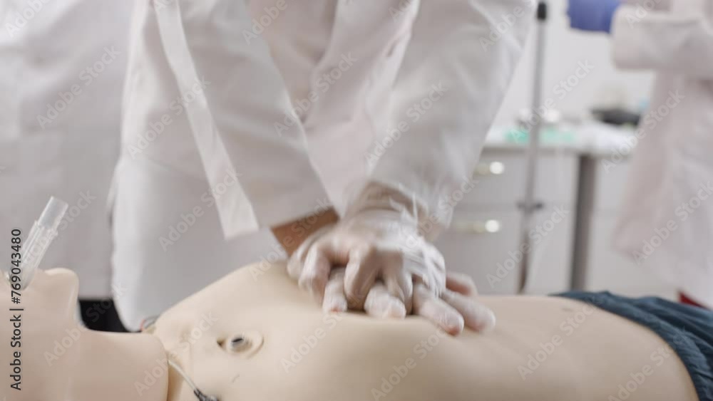 Medical professional performing procedure CPR on mannequin Medical professional performing procedure CPR on mannequin