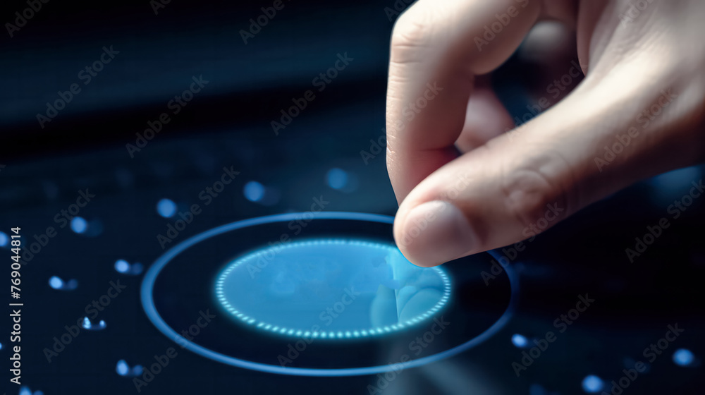A man is pointing at a computer screen with a blue button in the middle. A man is pointing at a computer screen with a blue button in the middle.