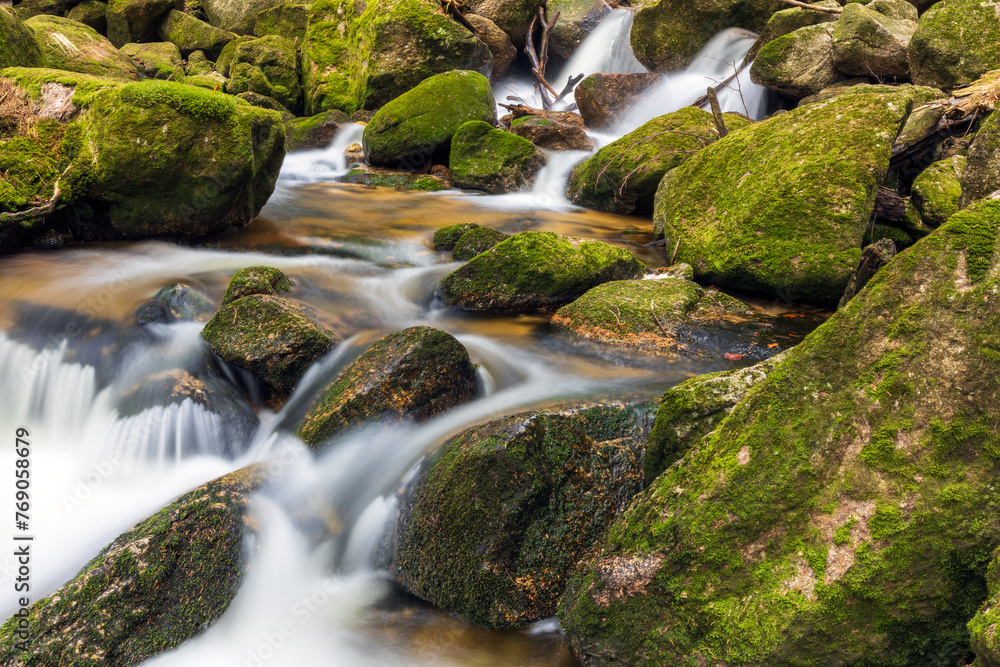 A beautiful view of a romantic stream in a wild mountain valley A beautiful view of a romantic stream in a wild mountain valley