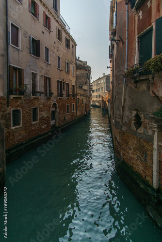 Typical narrow canal surrounded by buildings in Venice, Veneto, Italy