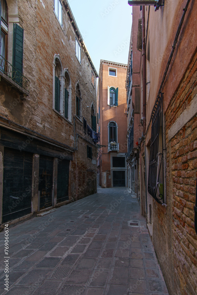 Townscape of a small narrow street with typical facades in Venice, Veneto, Italy
