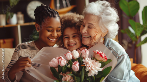 Heartwarming moment as grandmother hugs her granddaughters, who present her with tulips to celebrate International Women's Day. #769066839
