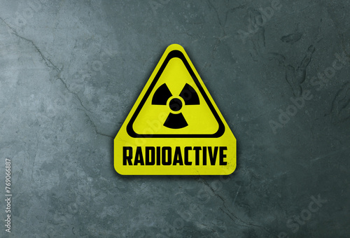 Radioactive sign on grey stone wall. Hazard symbol