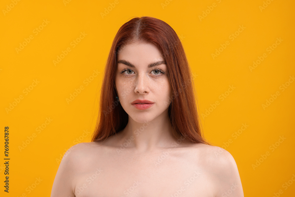 Portrait of beautiful woman with freckles on yellow background Portrait of beautiful woman with freckles on yellow background