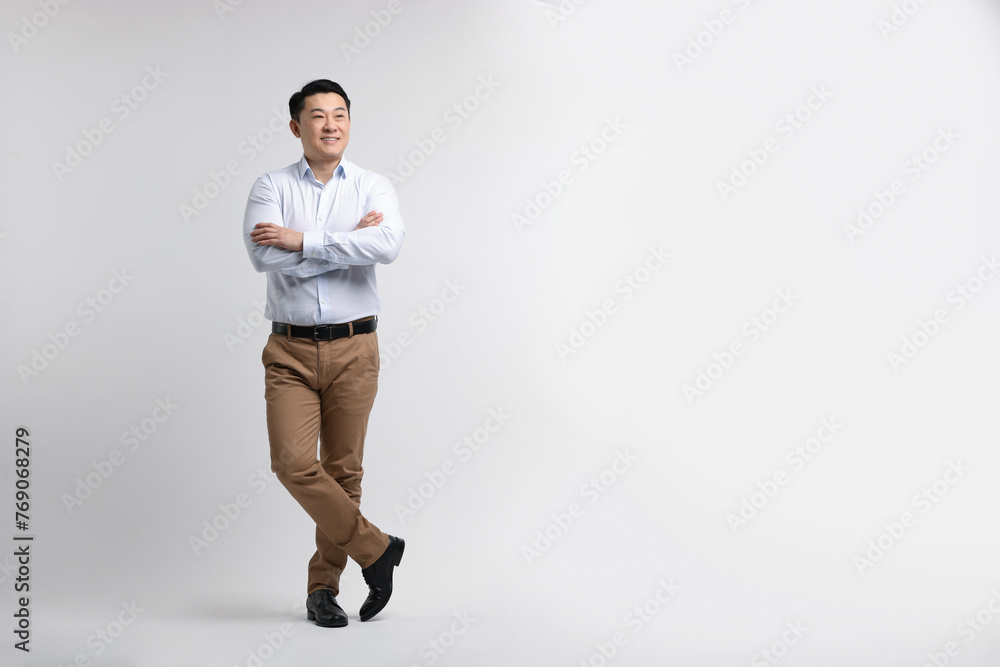 Full length portrait of happy man on light background. Space for text Full length portrait of happy man on light background. Space for text