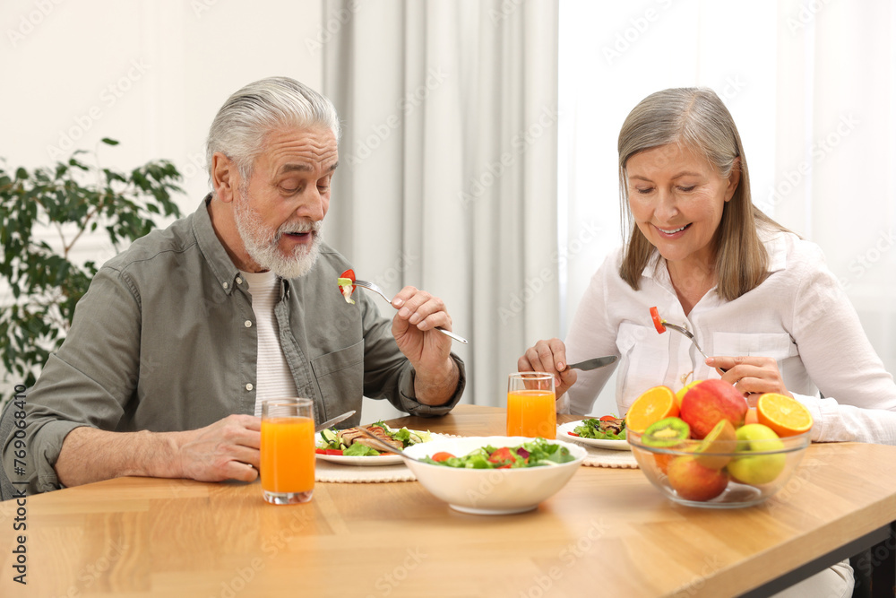 Happy senior couple having dinner at home Happy senior couple having dinner at home